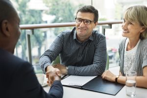 Mand and woman discuss retirement with their financial consultant