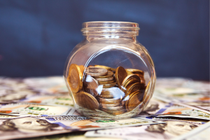 Jar filled with coins labeled FERS/Offset, symbolizing retirement savings and offsets.