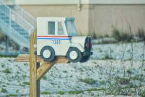 Mailbox shaped like a mail truck, symbolizing choosing the right postal service health plan.