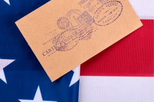 Letter resting on an American flag, symbolizing Postal Service Health Benefits and federal service.